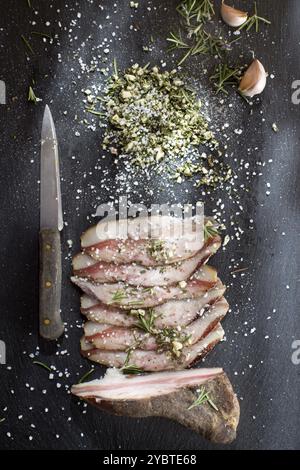 Presentation of salted pork bacon on stone slate Stock Photo