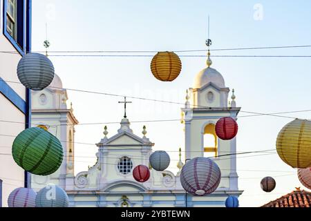 Church tower in the streets of the city of Diamantina decorated with colorful lanterns and light fixtures Stock Photo
