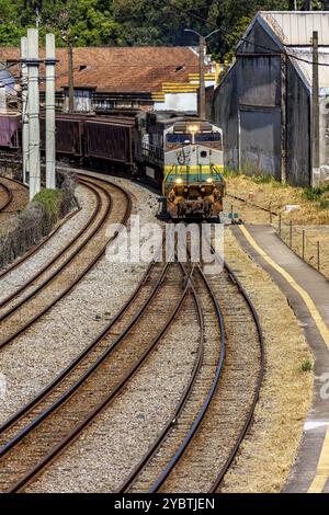 Train loaded with iron ore crossing the city in Minas Gerais, Brazil, South America Stock Photo