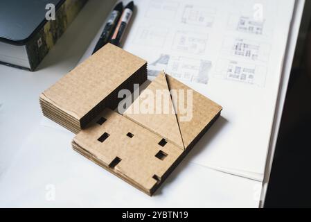 Architect Desk With Cardboard Architectural Model and Hand-drawn Plan Sketches. Selective focus Stock Photo