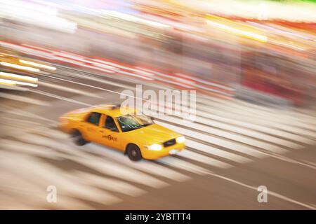 Panning image of a Yellow Taxi cab in Times Square, New York City. New York. USA Stock Photo