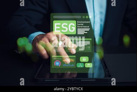 Man hand using stylus pen to analyze ESG on screen in business investment strategy concept, ESG environment social governance investment business conc Stock Photo