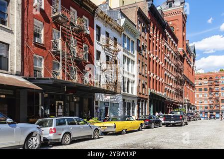 New York City, USA, June 25, 2018: Street scene with classic yellow Cadillac Eldorado convertible car in Tribeca District of Manhattan a sunny day of Stock Photo