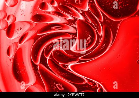 Twirling effect of bubbles on surface of water in dark red gradient background Stock Photo