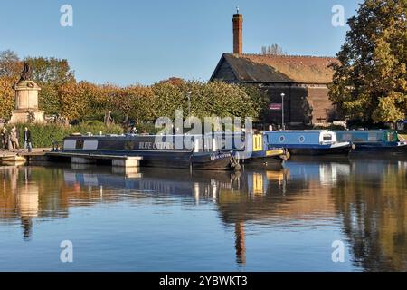 Bancroft basin, Stratford upon Avon with narrow boats moored on calm water and in the Autumn evening light. England, UK Stock Photo