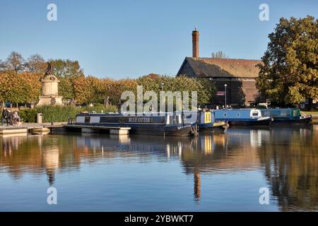 Bancroft basin, Stratford upon Avon with narrow boats moored on calm water and in the Autumn evening light. England, UK Stock Photo