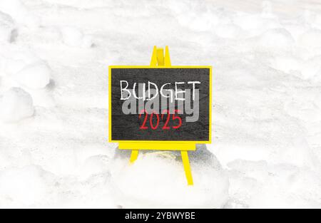Planning budget 2025 new year symbol. Concept words Budget 2025 on beautiful yellow chalk blackboard. Beautiful white snow background. Business budget Stock Photo