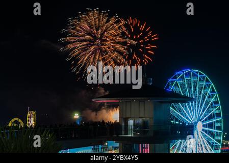 Fireworks displays at Southend on Sea, Essex, UK, with the fireworks launched from a barge out on the estuary. People watching from observation tower Stock Photo