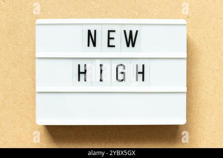 Lightbox with word new high on wood background Stock Photo