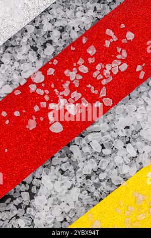 This image shows a close-up of a surface with three distinct colored stripes: white, red, and yellow. Stock Photo