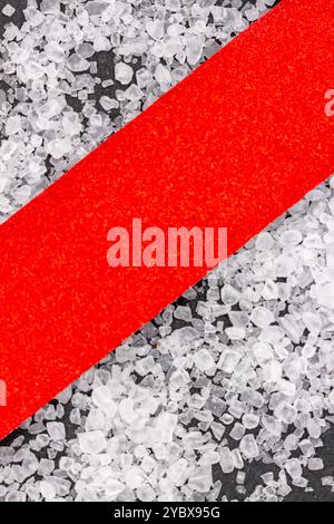 This image features a close-up view of a textured surface with a diagonal red strip running through it. Stock Photo