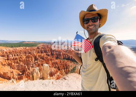 Handsome young tourist enjoying summer holiday in usa,  - Traveling life style concept with smiling man taking selfie on Bryce natural park - Tourism Stock Photo