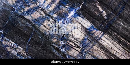 Blue granite slab with natural veining, offering a detailed texture for design projects. Stock Photo