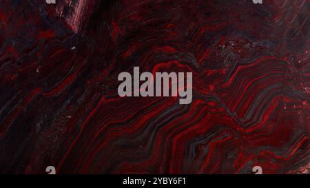 Close-up of red granite slab with natural veining, perfect for texture or design use. Stock Photo