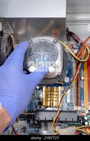 Technician Installing CPU Cooler on Motherboard Stock Photo