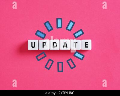 Update loading concept. The word update on cubes with loading symbol over pink background Stock Photo