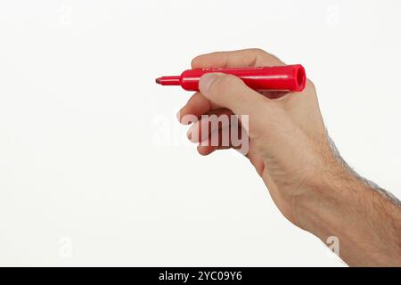 A man writing with red color marker isolated on white. Space for text. Stock Photo