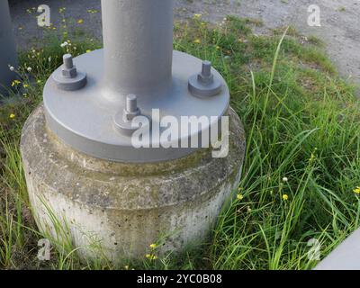 The steel column base, firmly screwed into the concrete foundation, Stock Photo