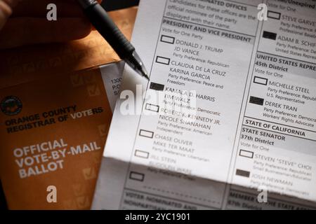 Fullerton, California, USA - October 20, 2024: Filling out a vote by mail ballot in favor of Kamala Harris and Tim Walz for president. Stock Photo