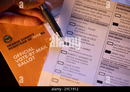 Fullerton, California, USA - October 20, 2024: Filling out a vote by mail ballot in favor of Kamala Harris and Tim Walz for president. Stock Photo