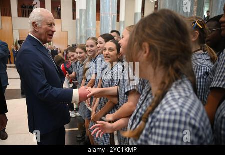 King Charles III speaks to school children at the Ceremonial Welcome to Australia at Australian Parliament House in Canberra, marking the King's first visit as sovereign to Australian Parliament House, on day two of the royal visit to Australia and Samoa. Picture date: Monday October 21, 2024. Stock Photo