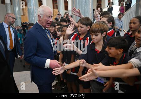 King Charles III speaks to school children at the Ceremonial Welcome to Australia at Australian Parliament House in Canberra, marking the King's first visit as sovereign to Australian Parliament House, on day two of the royal visit to Australia and Samoa. Picture date: Monday October 21, 2024. Stock Photo