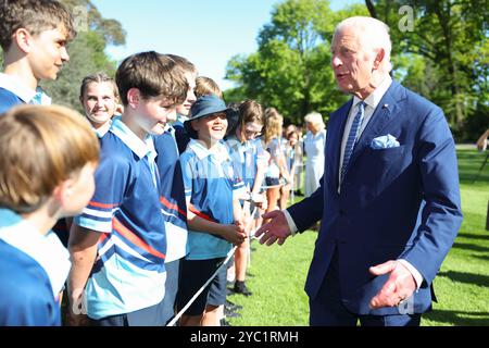 King Charles III speaks to schoolchildren from Wamberal Public School in the garden of Government House in Canberra, on day two of the royal visit to Australia and Samoa. To mark every Royal Visit to Government House dating back to 1985, members of the Royal Family have been invited to participate in a tradition of tree planting within the grounds. Picture date: Monday October 21, 2024. Stock Photo