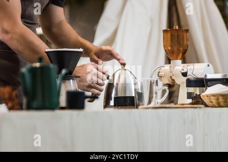 Professional coffee maker - Barista using coffee siphon brewing hot espresso at coffee shop coffee brewing syphon alternative method. Startup Business Stock Photo
