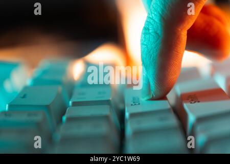 Press enter button on a keyboard with orange and teal light Stock Photo