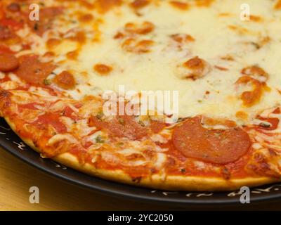 Pepperoni pizza, pizza with tomato sauce and spicy salami seasoned with paprika and chili peppers topping Stock Photo