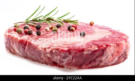 Raw ribeye steak with peppercorn and rosemary isolated on white background. Closeup. Stock Photo