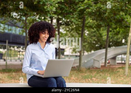 female entrepreneur working remotely on laptop Stock Photo