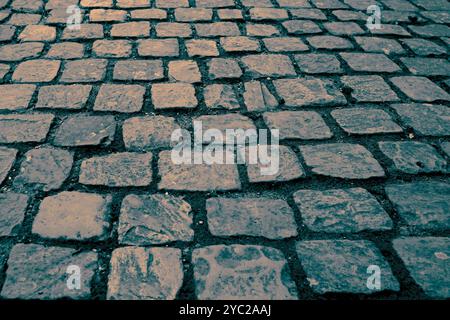 block paving path pavement sidewalk background backdrop in an old English street. With colour toning Stock Photo