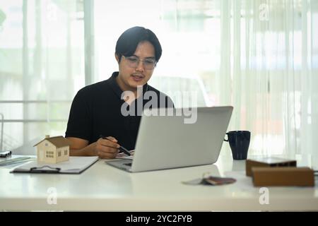 Handsome asian man working with interior design project at creative office Stock Photo