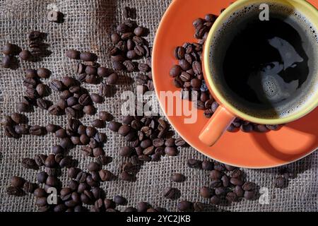 coffee beans on sack cloth with cup and saucer Stock Photo