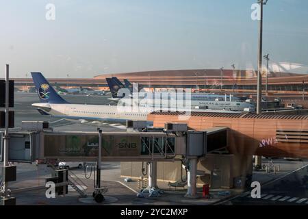 View of King Abdulaziz International Airport in Jeddah, Saudi Arabia, Middle East. Passenger terminal with Saudia planes under fuel service Stock Photo