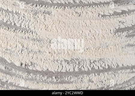 Grey cooking background of spilled wheat flour on stone background, top view. Stock Photo
