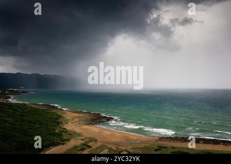 Stormy clouds and rain closing to the beach Stock Photo