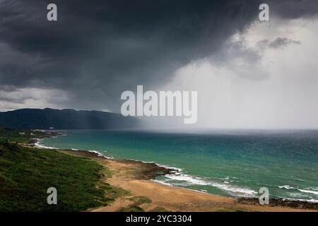 Stormy clouds and rain closing to the beach Stock Photo