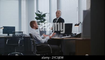 In modern office: Discussion between head of analytical department and manager about financial strategy. Personal computer screen shows equity and shares market. International stock exchange company. Stock Photo