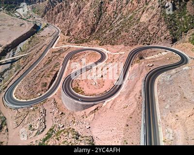 Bendy mountain road across the the Andes mountains near Potrerillos, Argentina. Aerial view. Stock Photo