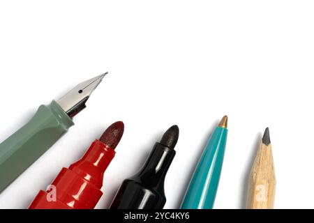 Pencils and pens and markers stand out on white background with dedicated copy space Stock Photo