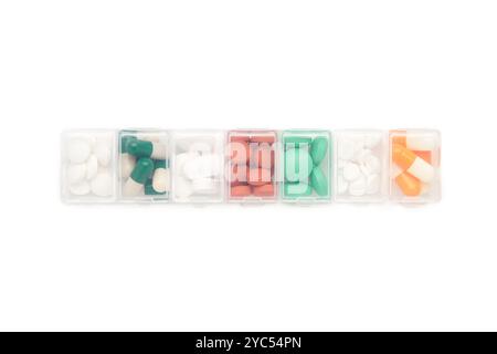 Daily pill box with medications and nutritional supplements isolated on white. Top view Stock Photo