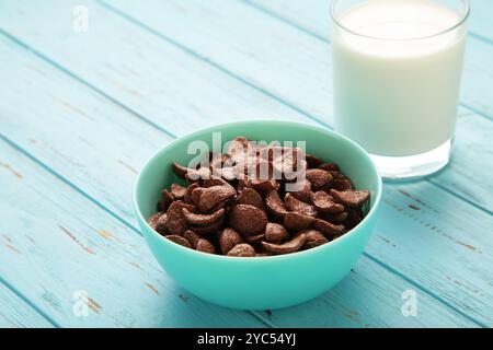 Set of various breakfast cereals with glass of milk on blue background. Top view Stock Photo