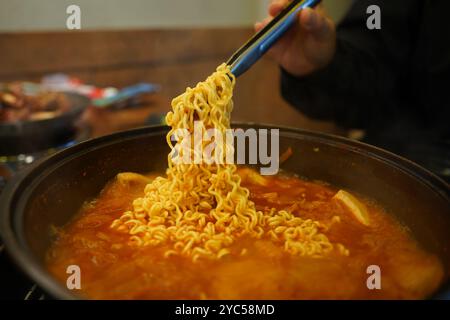 Add instant ramen to the kimchi stew broth and boil Stock Photo