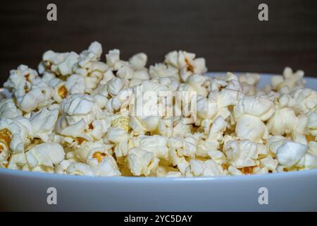 popcorn close up. popcorn with selective focus. popcorn, corn grains on a wooden table Stock Photo