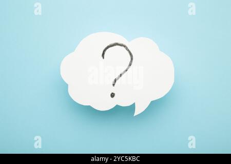 Question mark speech bubble on blue background. Top view Stock Photo