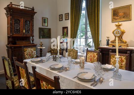 Dinner table with antique tableware in dining room inside 18th century clergy house Schriek at open air museum Bokrijk, Limburg, Flanders, Belgium Stock Photo