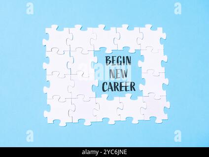 Puzzle pieces surrounding the phrase Begin new career on a light blue background. A motivational visual for career change or professional development Stock Photo