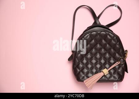 Backpack with leather keychain on pink background, top view. Space for text Stock Photo